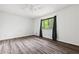 Neutral bedroom featuring wood-look floors, white walls, and a window at 1832 Tree Top Ct, Marietta, GA 30062