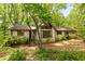 Charming home featuring a gable roof and lots of windows surrounded by mature trees at 1832 Tree Top Ct, Marietta, GA 30062