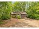 Single Gathering home exterior featuring a garage and neutral siding with lush surrounding landscape at 1832 Tree Top Ct, Marietta, GA 30062