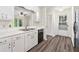 Modern kitchen featuring hardwood floors, white cabinets, and stainless steel appliances at 1832 Tree Top Ct, Marietta, GA 30062