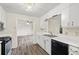 Updated kitchen with white cabinets, wood-look floors, and modern appliances open to living space at 1832 Tree Top Ct, Marietta, GA 30062