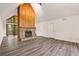 Spacious living room with hardwood floors, a stone fireplace, and views of the outdoors at 1832 Tree Top Ct, Marietta, GA 30062