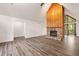 Open-concept living room with hardwood floors, a stone fireplace, and a large window at 1832 Tree Top Ct, Marietta, GA 30062