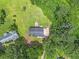Aerial view of a house with a spacious backyard and lush green surroundings at 28 Fawn Ct, Sharpsburg, GA 30277