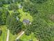 Aerial view showcasing a home nestled in a serene, heavily wooded area at 28 Fawn Ct, Sharpsburg, GA 30277