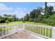 View from the wooden back deck showcasing the expansive, lush green backyard at 28 Fawn Ct, Sharpsburg, GA 30277