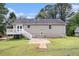 Exterior back view, showing the house, deck, and a concrete patio area at 28 Fawn Ct, Sharpsburg, GA 30277