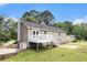 Back exterior featuring a deck, a two-story house and lush landscaping at 28 Fawn Ct, Sharpsburg, GA 30277