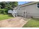 Back exterior view of the house featuring a deck and small patio area at 28 Fawn Ct, Sharpsburg, GA 30277