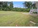 Spacious backyard view with lush green lawn and the back of the house at 28 Fawn Ct, Sharpsburg, GA 30277