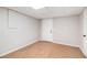 View of basement room with carpet, white walls and a door leading to outside at 28 Fawn Ct, Sharpsburg, GA 30277