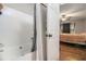 Bathroom featuring a shower-tub combination next to a bedroom with hardwood floors at 28 Fawn Ct, Sharpsburg, GA 30277