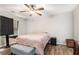 Comfortable bedroom featuring natural lighting, ceiling fan, and wood-look flooring at 28 Fawn Ct, Sharpsburg, GA 30277