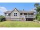 Charming home featuring a gray exterior, front porch, and well-maintained lawn at 28 Fawn Ct, Sharpsburg, GA 30277
