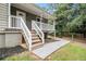 Exterior view showcasing the home's entrance with steps, a porch, and landscaping at 28 Fawn Ct, Sharpsburg, GA 30277
