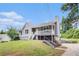 Charming front exterior showcasing the home's inviting porch and well-manicured lawn at 28 Fawn Ct, Sharpsburg, GA 30277