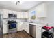 Clean kitchen featuring stainless steel appliances and white cabinetry and countertops at 28 Fawn Ct, Sharpsburg, GA 30277