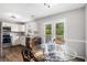 Eat-in kitchen with white cabinetry, stainless steel appliances, and ample natural light at 28 Fawn Ct, Sharpsburg, GA 30277