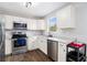 Modern kitchen with stainless steel appliances, white cabinets, and stone countertops at 28 Fawn Ct, Sharpsburg, GA 30277