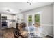 Eat-in kitchen with white cabinets, stainless appliances, and glass doors to the deck at 28 Fawn Ct, Sharpsburg, GA 30277