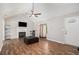 Bright living room boasts vaulted ceilings, wood floors, and a fireplace at 28 Fawn Ct, Sharpsburg, GA 30277