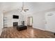 Bright living room boasts a fireplace, wood floors, and vaulted ceilings at 28 Fawn Ct, Sharpsburg, GA 30277