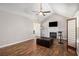 Inviting living room with vaulted ceilings, wood floors, and a cozy fireplace at 28 Fawn Ct, Sharpsburg, GA 30277