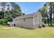 Side exterior showcasing the house's architecture and surrounding landscape at 28 Fawn Ct, Sharpsburg, GA 30277