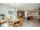Open concept dining room boasts hardwood floors, modern chandelier, and flows to a large modern kitchen at 4380 Serenity Lake Dr, Cumming, GA 30028