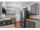 Modern kitchen featuring stainless steel appliances, countertops, and gray cabinetry at 4090 Tara Dr, Forest Park, GA 30297