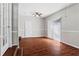 Spacious living room featuring hardwood floors, ceiling fan, and sliding glass doors to outdoor space at 4090 Tara Dr, Forest Park, GA 30297