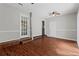 Bright living room with hardwood floors and a modern ceiling fan, plus a door to the exterior at 4090 Tara Dr, Forest Park, GA 30297