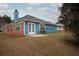 A nice view of the backyard with a brick and blue house with a gray roof and patio at 4931 Wilkins Station Dr, Decatur, GA 30035