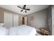 Bedroom features neutral walls, a ceiling fan, hardwood floors, and a closet with bright doors at 4931 Wilkins Station Dr, Decatur, GA 30035