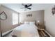 Cozy bedroom with neutral-colored walls, a ceiling fan, a window, and a comfortable bed with linens at 4931 Wilkins Station Dr, Decatur, GA 30035