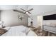 Light-filled bedroom boasts ceiling fan, wood-look floors, and access to a private bathroom at 4931 Wilkins Station Dr, Decatur, GA 30035