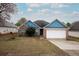 Charming single-Gathering home with blue trim, brick accents, and an attached two-car garage at 4931 Wilkins Station Dr, Decatur, GA 30035