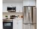 Well-equipped kitchen featuring white cabinets, stainless steel appliances, and modern fixtures at 4931 Wilkins Station Dr, Decatur, GA 30035