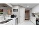 Bright, white kitchen featuring stainless steel appliances, marble floors, and quartz countertops at 4931 Wilkins Station Dr, Decatur, GA 30035