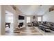 Bright living room featuring a fireplace, large TV, and comfortable seating area with wood flooring at 4931 Wilkins Station Dr, Decatur, GA 30035