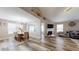 Well-lit living and dining area featuring modern light fixture, hardwood flooring, and vaulted ceilings at 4931 Wilkins Station Dr, Decatur, GA 30035