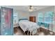 Bedroom with hardwood floors, large windows, and a cozy bed at 5400 Francis Ave, Stone Mountain, GA 30087