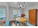 Bright dining room with wood floors, a round wood table, and a colorful chandelier at 5400 Francis Ave, Stone Mountain, GA 30087
