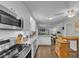 Updated kitchen with white cabinetry, stainless steel appliances, granite countertops and an eat-in island at 5400 Francis Ave, Stone Mountain, GA 30087