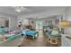 Bright open concept living room with hardwood floors, ceiling fan, and kitchen view at 5400 Francis Ave, Stone Mountain, GA 30087