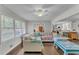 Bright open living room with hardwood floors, ceiling fan, and kitchen view at 5400 Francis Ave, Stone Mountain, GA 30087