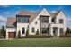 Elegant two-story home with a manicured lawn and beautiful landscaping at 125 Spring Dr, Roswell, GA 30075
