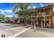 Two-story building with covered balconies, showcasing a charming architectural design and vibrant street scene at 125 Spring Dr, Roswell, GA 30075