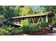 Exterior of a covered wooden bridge with natural surroundings, offering a peaceful and scenic view at 125 Spring Dr, Roswell, GA 30075