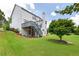 Backyard view of a white two-story home with a deck and well-maintained lawn at 5003 Pacific Dunes Dr, Suwanee, GA 30024